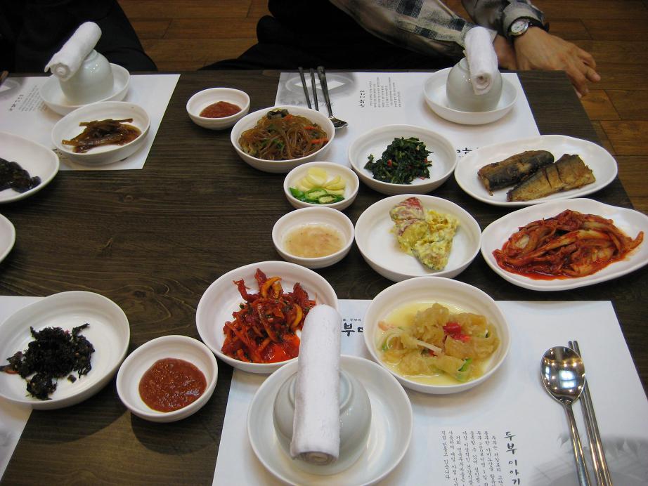 A table full of Korean banchan side dishes at a restaurant
